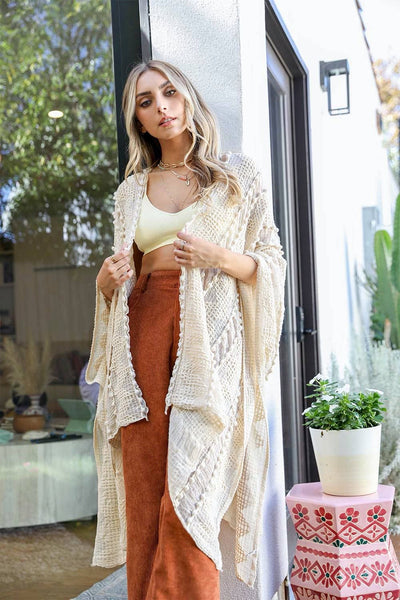 Cream colored zig zag soft fabric kimono that's light weight and flowy i open in the front and the sleeves are roomy.