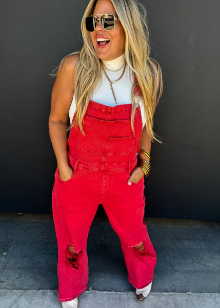 Red bib overalls are stylish and comfortable with distressed knee area. casual and fun