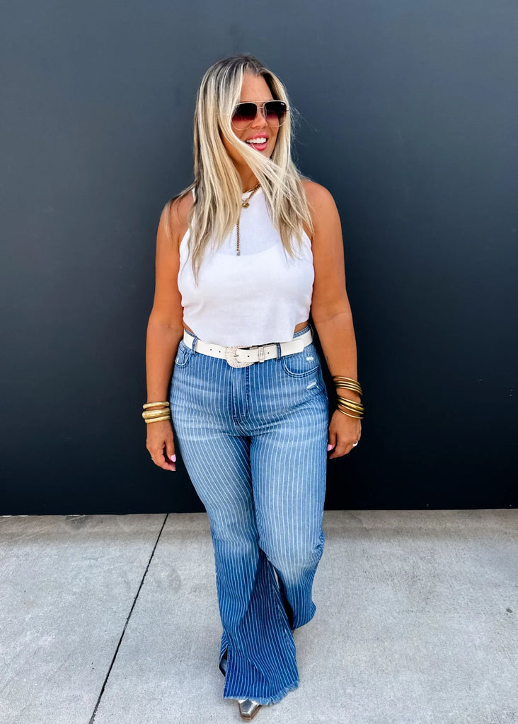 Pinstripe jeans by Blakeley have a frayed end of pant leg