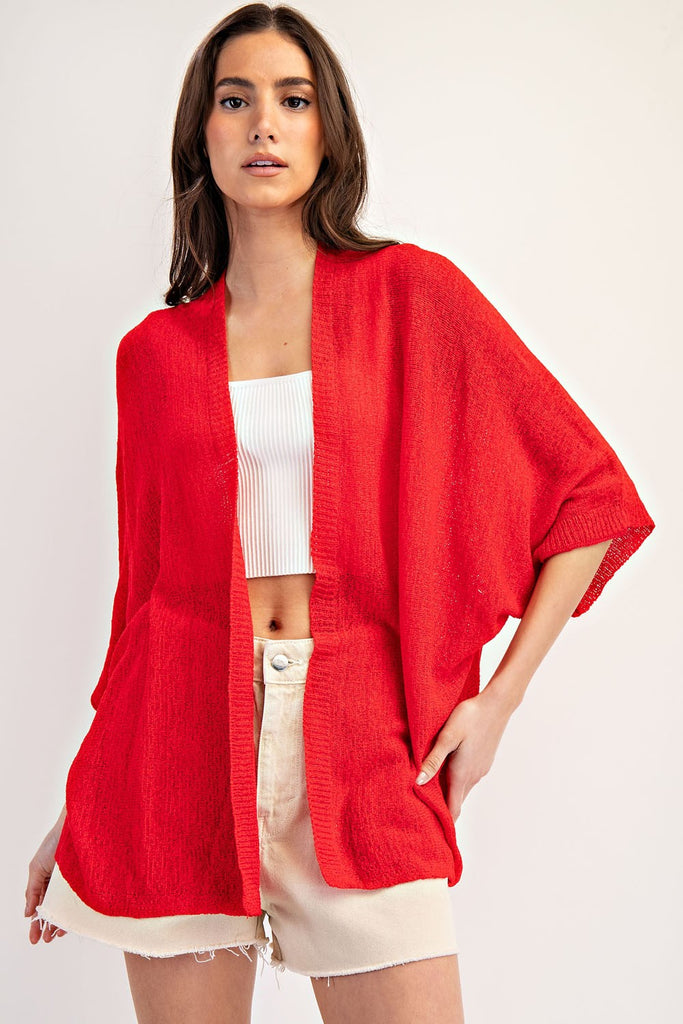 Kimono Style slouchy cardigan with short dolman sleeves made in knit fabric that's as comfy as your favorite pajamas, but way more stylish! This versatile piece drapes beautifully over any outfit, adding that perfect touch to any outfit. model wearing red with shorts and no jewelry.
