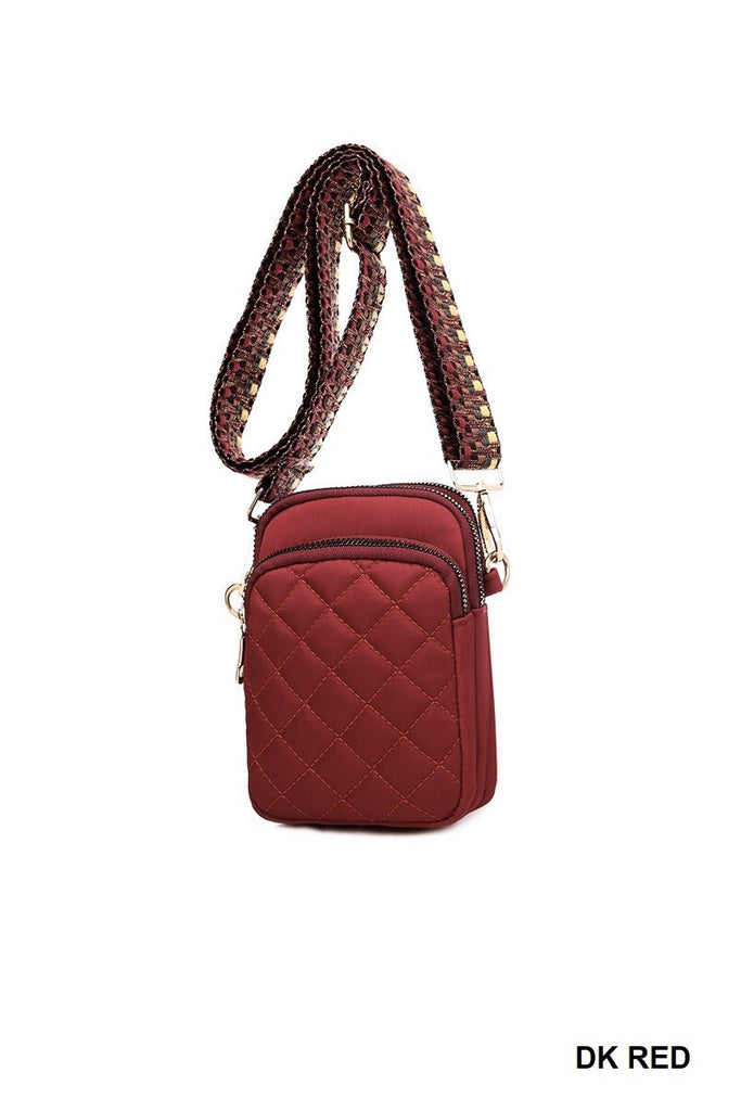 quilted crossbody/sling bag with several compartments for cash, cards, coin and personal items. Red fabric, golden hardware- the sling is adjustable