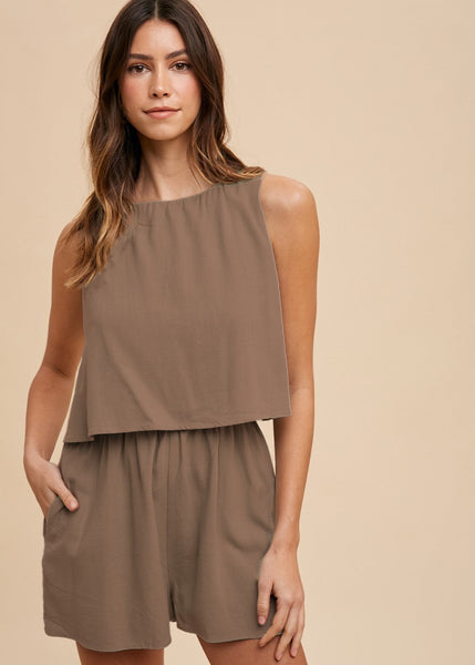 This mocha romper is elastic waisted with two pockets on the shorts and sleeveless top.
