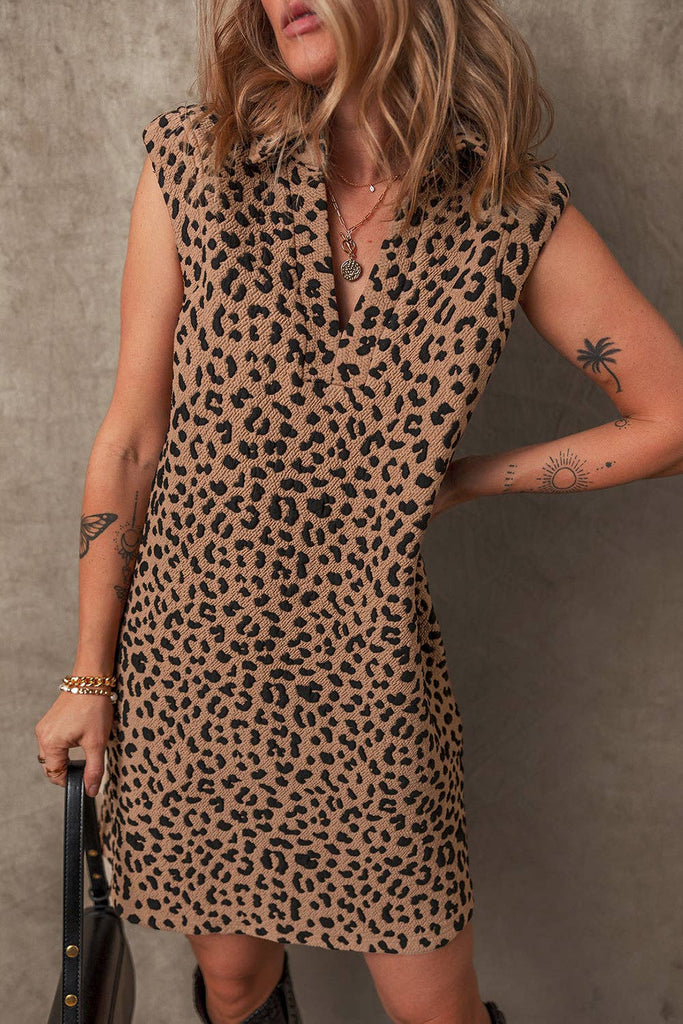 This light brown leopard print sleeveless, V-neck, collared dress also has pockets and is mid-thigh length