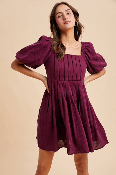 Plumb color box pleat mini dress with square neckline and puff short sleeves