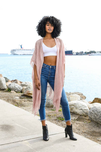 This boho chic piece features a lightweight, sheer design perfect for beach cover-ups, festivals, or casual evenings. Adorned with elegant sequin borders and stylish frayed trim, this trendy kimono is versatile for summer and any season
