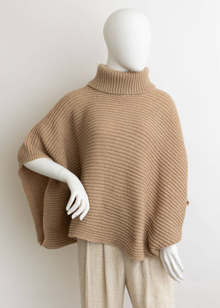 Tan color poncho with ribbed turtleneck that hits slightly below the waist