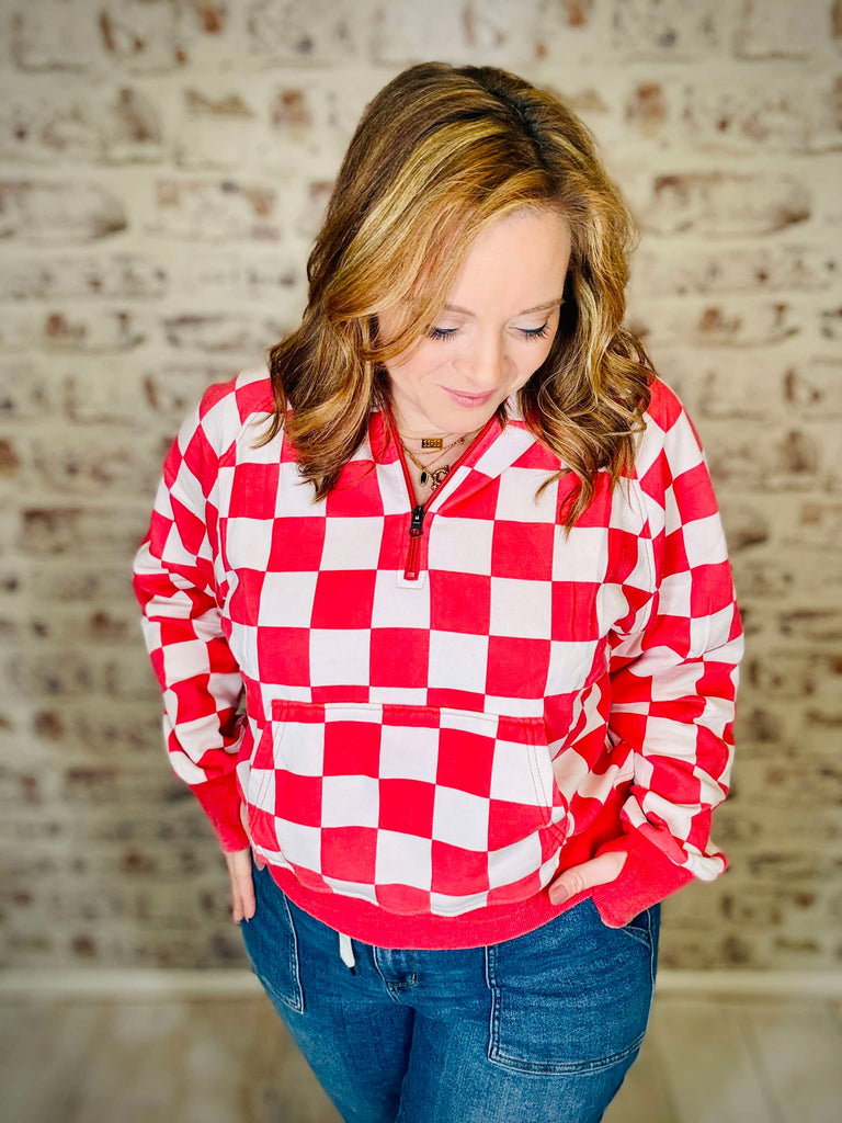 This red and white checkered quarter zipper front waist pocket pull over is true to size and comfortable