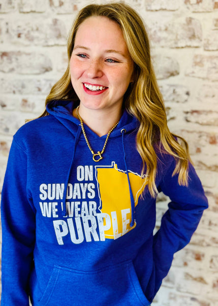 Purple game day solid Hoodie that says on "On Sundays We Wear PURPLE". The state of Minnesota Screenprinted in yellow-gold color