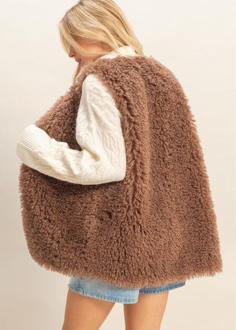 brown vest that is reminiscent of a Teddybear fur. Soft, fun and fluffy