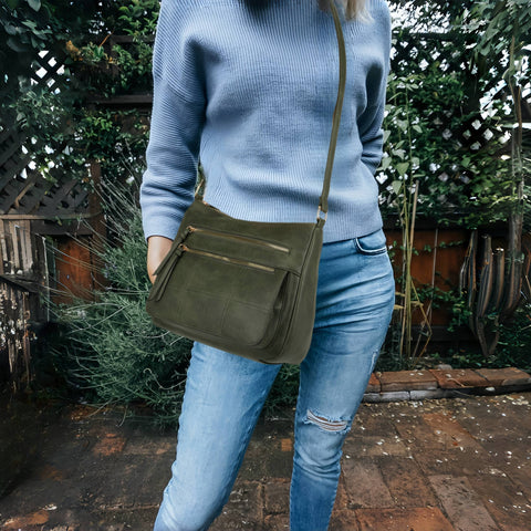 Multi-pocket crossbody vegan friendly bag with an adjustable shoulder strap.  Forest green in color