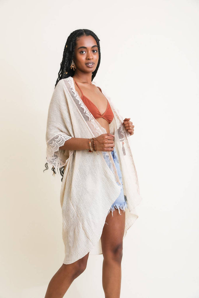 Elevate your wardrobe with our scallop lace trim textured kimono. This trendy and chic kimono features elegant scallop lace details and a stylish textured design. Perfect for vacation outfits or adding a touch of fashion to any look.