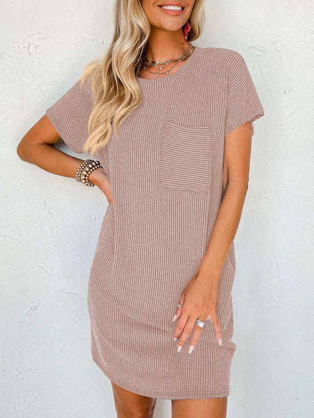 ribbed T shirt dress in the color of mocha with one chest pocket on the tight side.  Model is wearing bracelets and a necklace