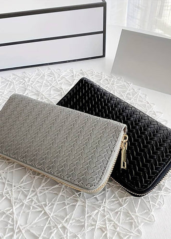 faux leather woven wallet.  can hold credit cards and cash and a few other items in the zippered area.