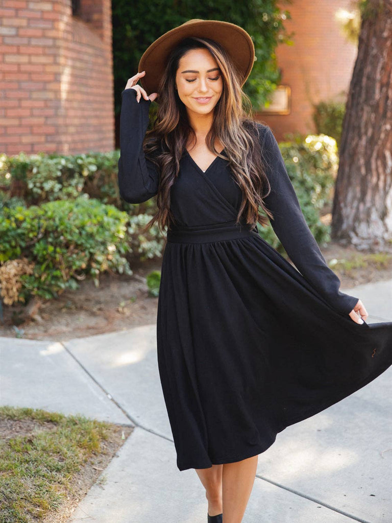 Black long sleeve black dress with a V-Neck and slight gather flowing skirt.