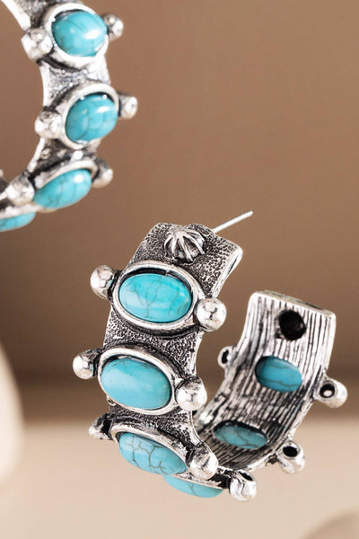 Chunky half hoops set with oval turquoise style cabochons and oxidized rope detailing for a bold Western look.