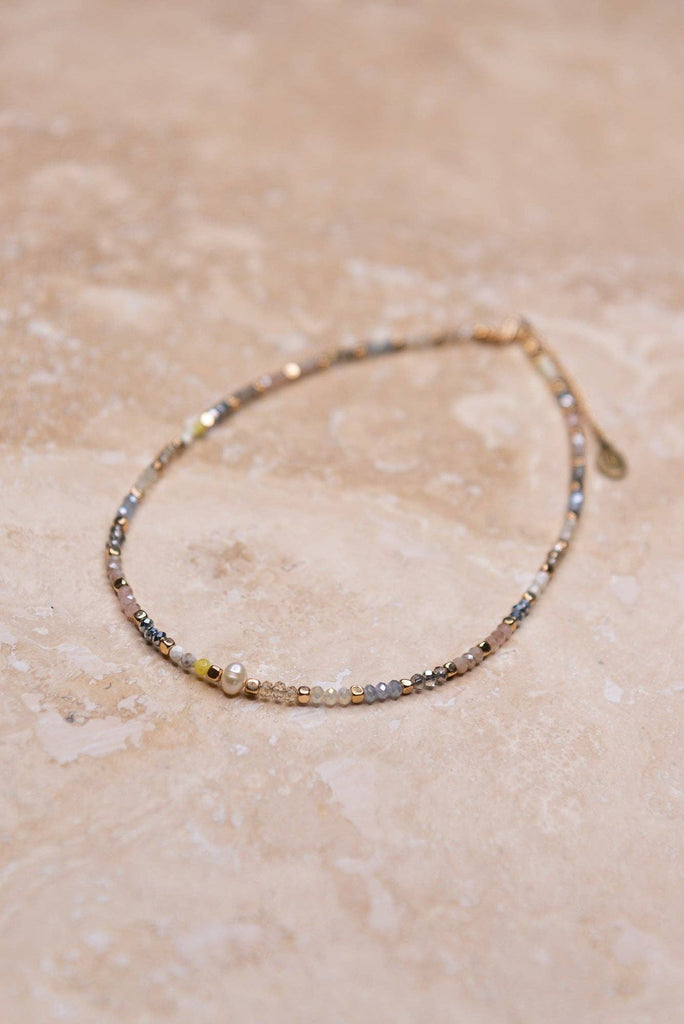 Adjustable, multi color beaded choker with pearl bead in center. 16" long