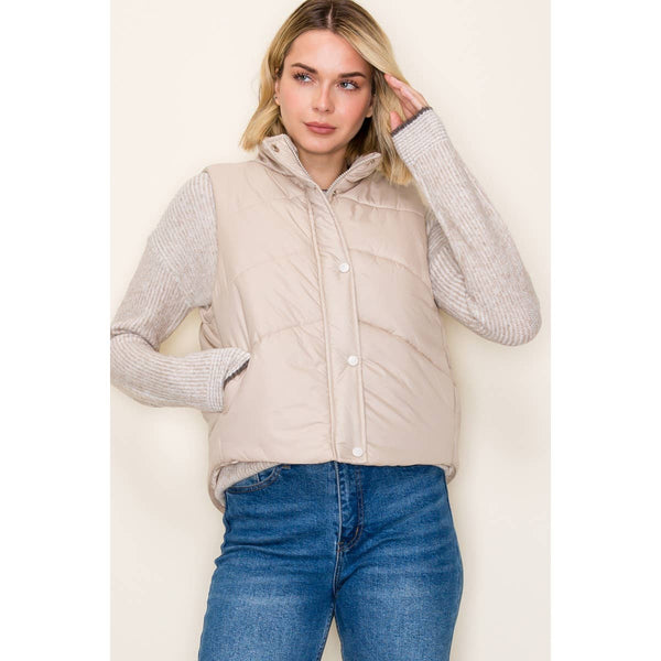 very light tan color puffer vest with side pockets and both zipper and button front