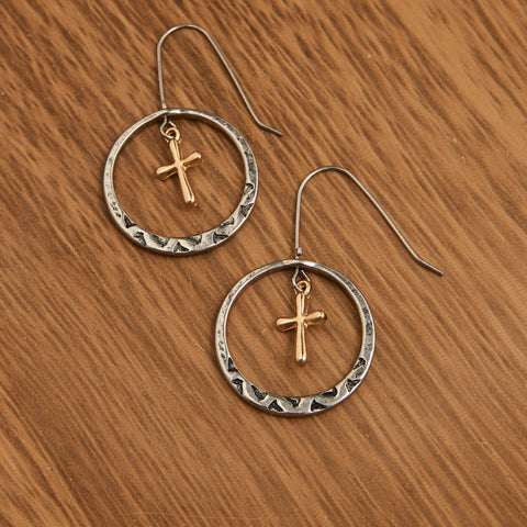 Silver toned circular earrings with gold cross centered in circle. The perfect blend of Faith, artistry and spirit