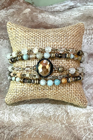 5 strand multi color and multi shaped chain link beaded Bracelet. Lobster claw clasp with 3" extender. Stones may vary in size and texture
