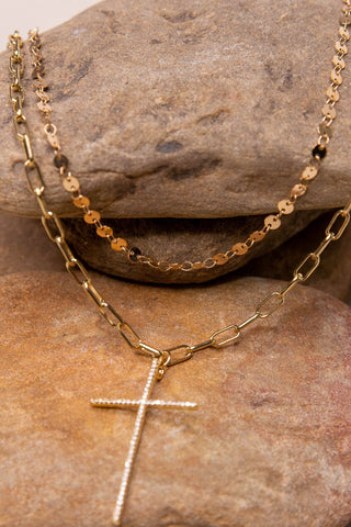 Gold, double layer necklace. One layer is a disc chain and the other is a link chain with a rhinestone cross pendant.