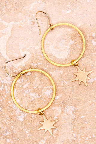 These earrings have a fishhook that connects a gold hoop with an 8-point star charm
