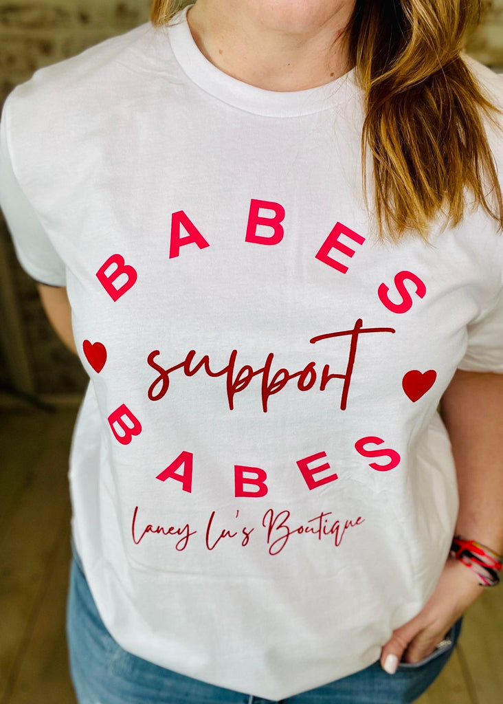 Woman wearing Babes Support Babes White T-Shirt with Pink Lettering 